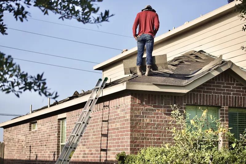 Professional roofer working on a residential roof in Serena